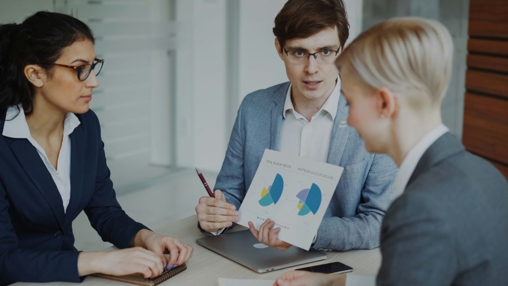 A group of business professionals looking at financals